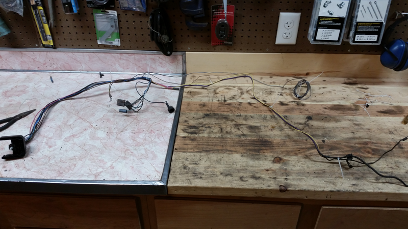 From left to right: firewall connector, ignition coil, wiper/washer motor, coil of wire (switched 12v feeds I kept from removed circuits), starter trigger